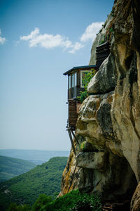 Scenic view of cliff by sea against sky