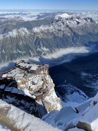 High angle view of snowcapped mountains against sky