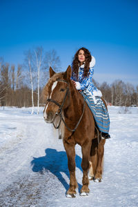 Portrait of person riding horse in winter