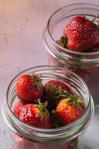 Close-up of strawberries in glass jar on table