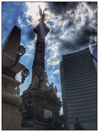 Low angle view of building against cloudy sky