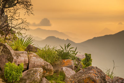 Scenic view of mountains against sky at sunset