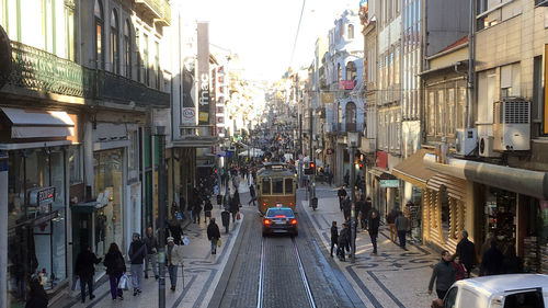 Vehicles on road amidst buildings in city