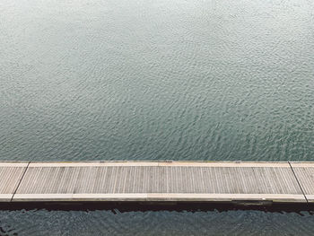 High angle view of railing by sea