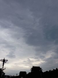 Low angle view of building against cloudy sky