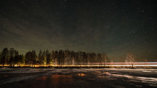 Scenic view of frozen lake against sky at night