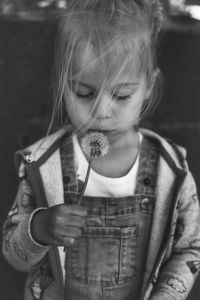 Portrait of cute girl with dandelion 