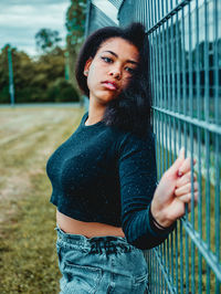 Portrait of beautiful woman standing against wall