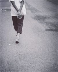 Rear view of woman standing on road