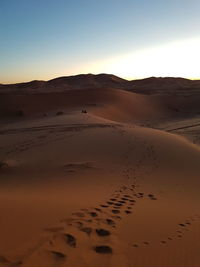 Sand dunes in desert against clear sky