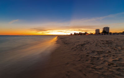 Scenic view of beach against sky during sunset