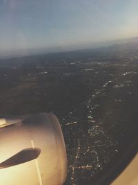 Cropped image of airplane flying over sea