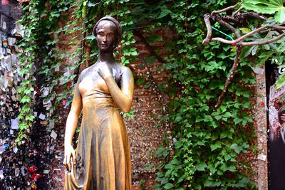 Low angle view of statue against trees in forest