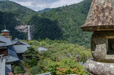 Scenic view of trees and houses against mountain