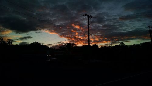 Silhouette landscape against scenic sky