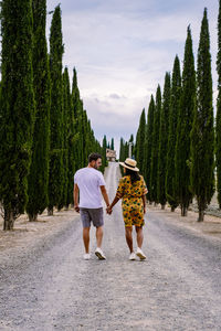 Rear view of people walking on road