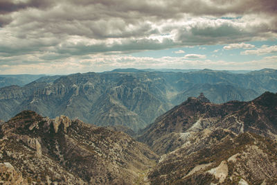 Scenic view of mountains against cloudy sky