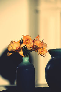 Close-up of flower vase on table at home