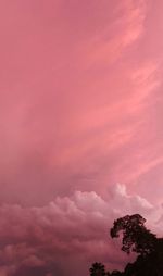 Low angle view of silhouette trees against romantic sky