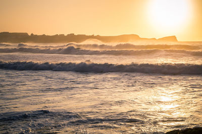 Scenic view of sea against sky during sunset