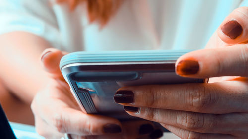 Midsection of woman using mobile phone