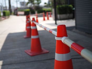 Close-up of red umbrella on road in city