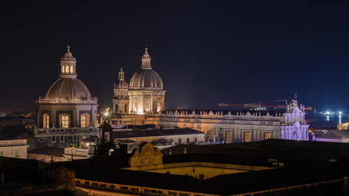 Illuminated building against sky at night