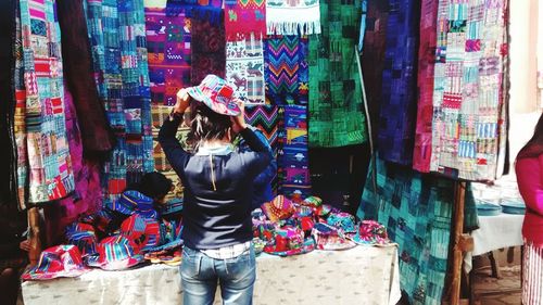 Rear view of woman standing at market stall