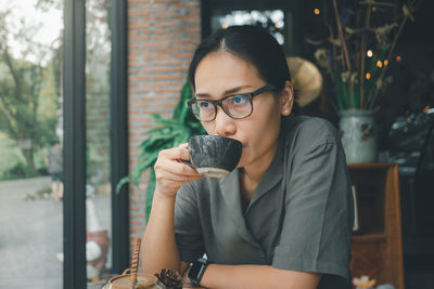 Portrait of woman drinking coffee