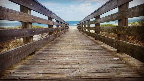 Wooden jetty leading to calm sea