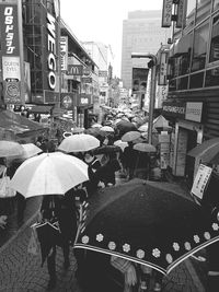 People walking on wet street in city