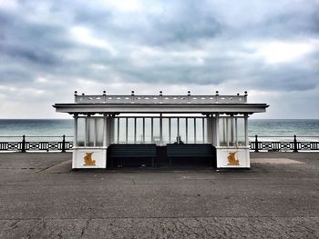 Built structure on pier at beach against sky