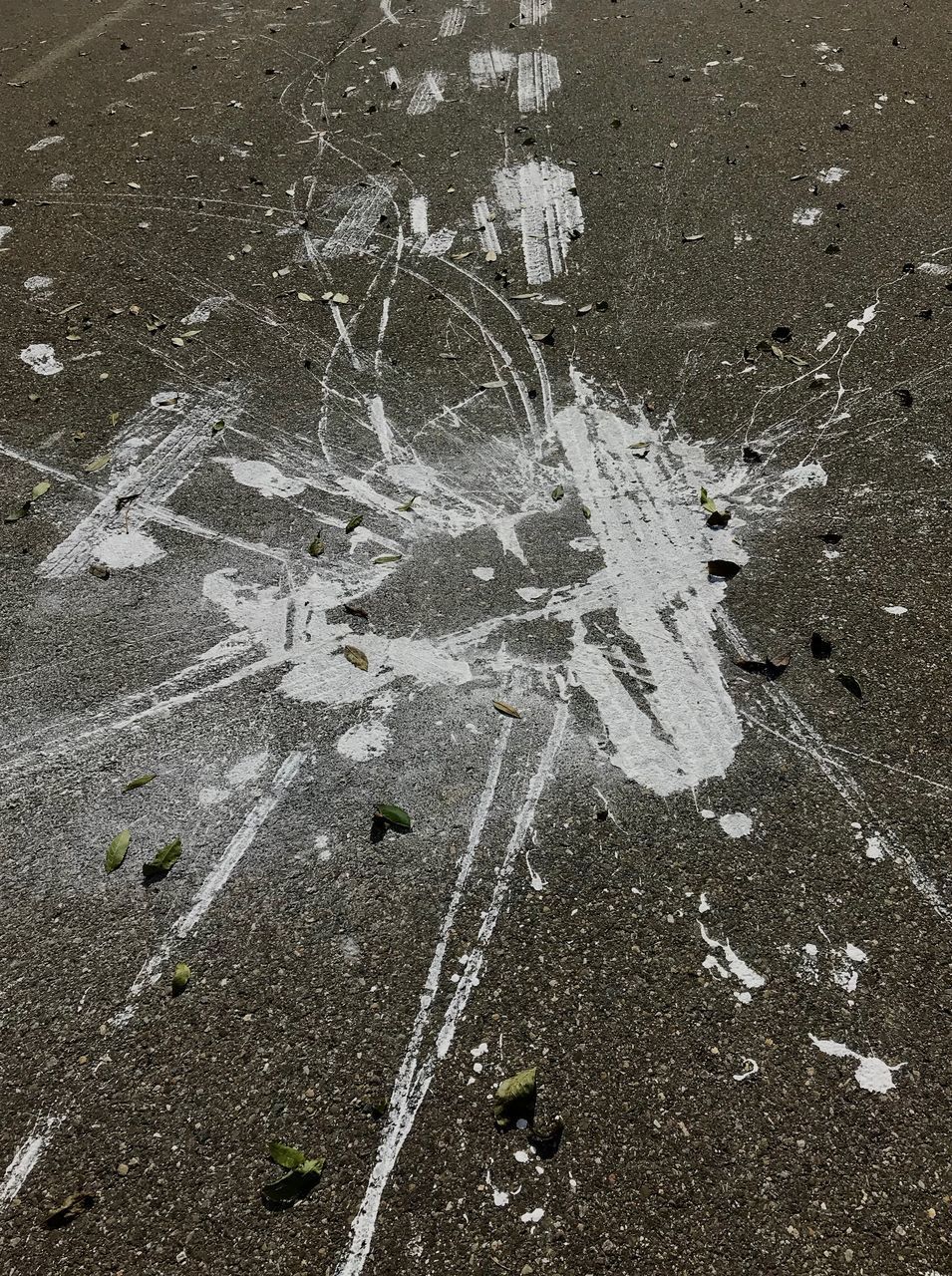 HIGH ANGLE VIEW OF CRACKED ROAD ON STREET