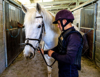 Rear view of man riding horse