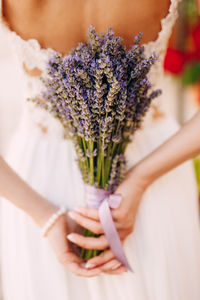 Midsection of woman holding flower bouquet