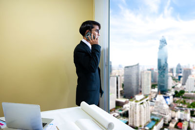 Man using mobile phone in city