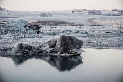 Scenic view of frozen lake against sky during winter