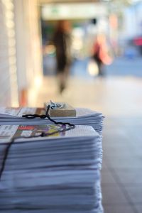Stack of newspapers on footpath