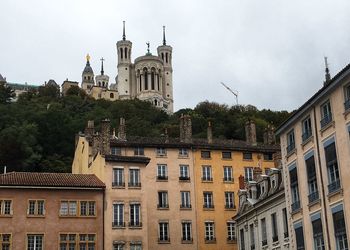 Low angle view of buildings in city against sky