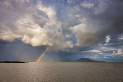 Big powerful storm clouds over the lake balaton of hungary with rainbow