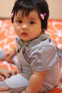 Portrait of cute baby girl at home
