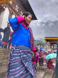 Women standing against wall in city