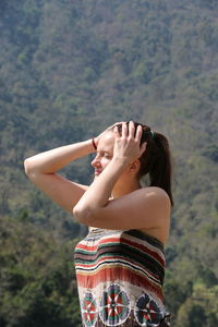 Low section of woman standing against sky