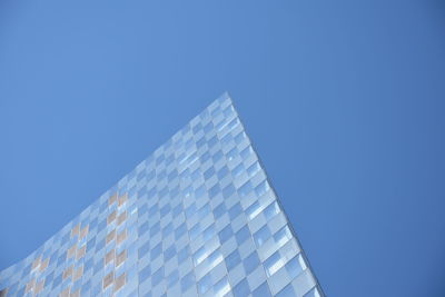 Low angle view of modern building against clear blue sky