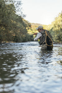 Man sitting in river