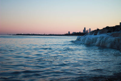 Scenic view of sea against clear sky during sunset