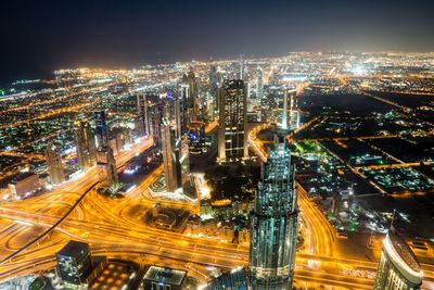 High angle view of illuminated city buildings at night