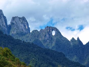 Scenic view of mountains against cloudy sky