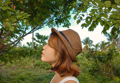 Portrait of a beautiful young woman against trees