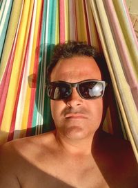 Portrait of man wearing sunglasses at home